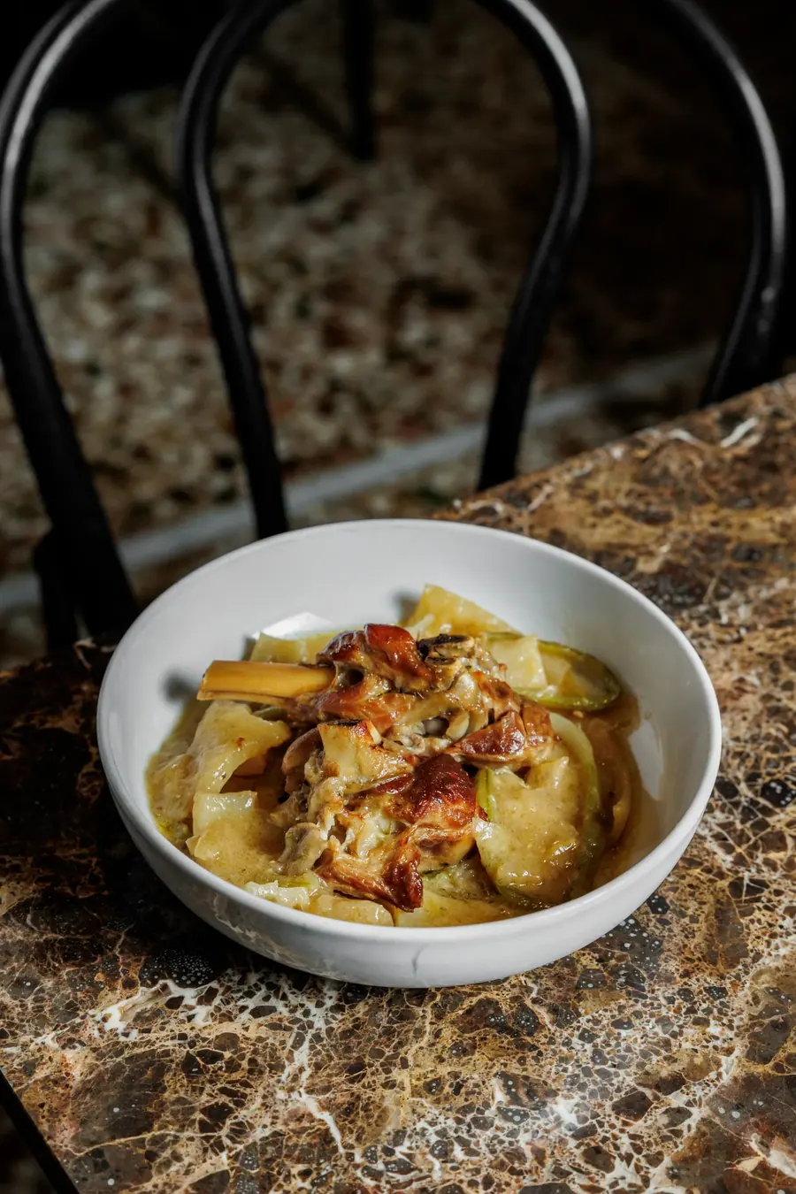 Potatoes with cured pork in a shallow bowl