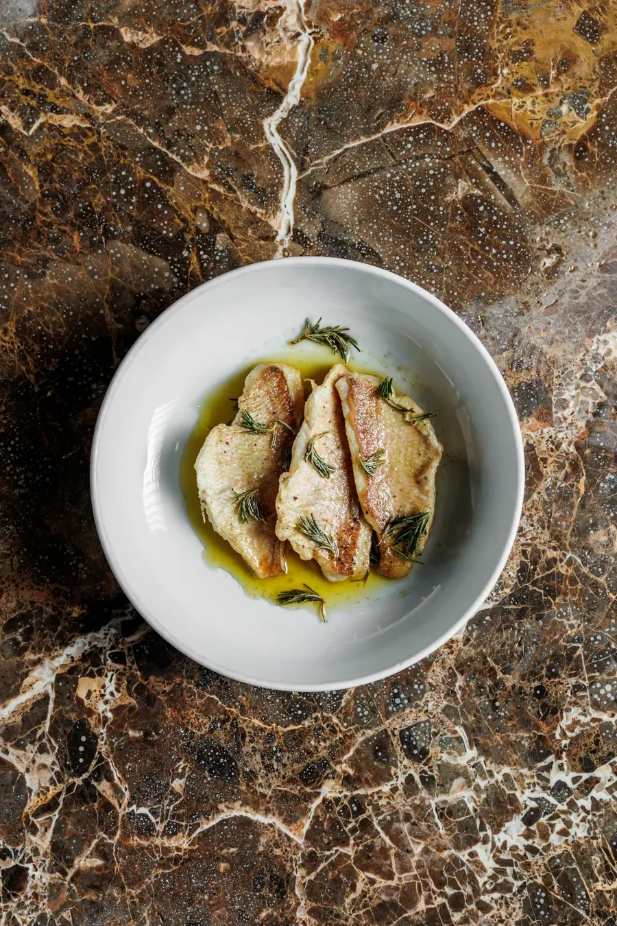 Fish poached in olive oil