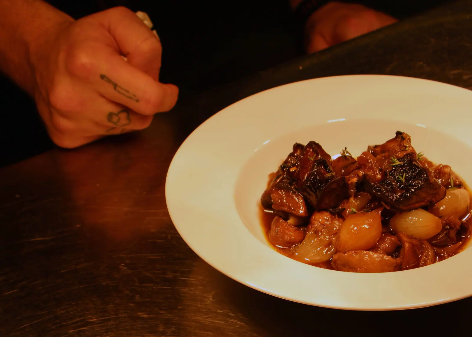 Meatballs in red sauce on a white plate