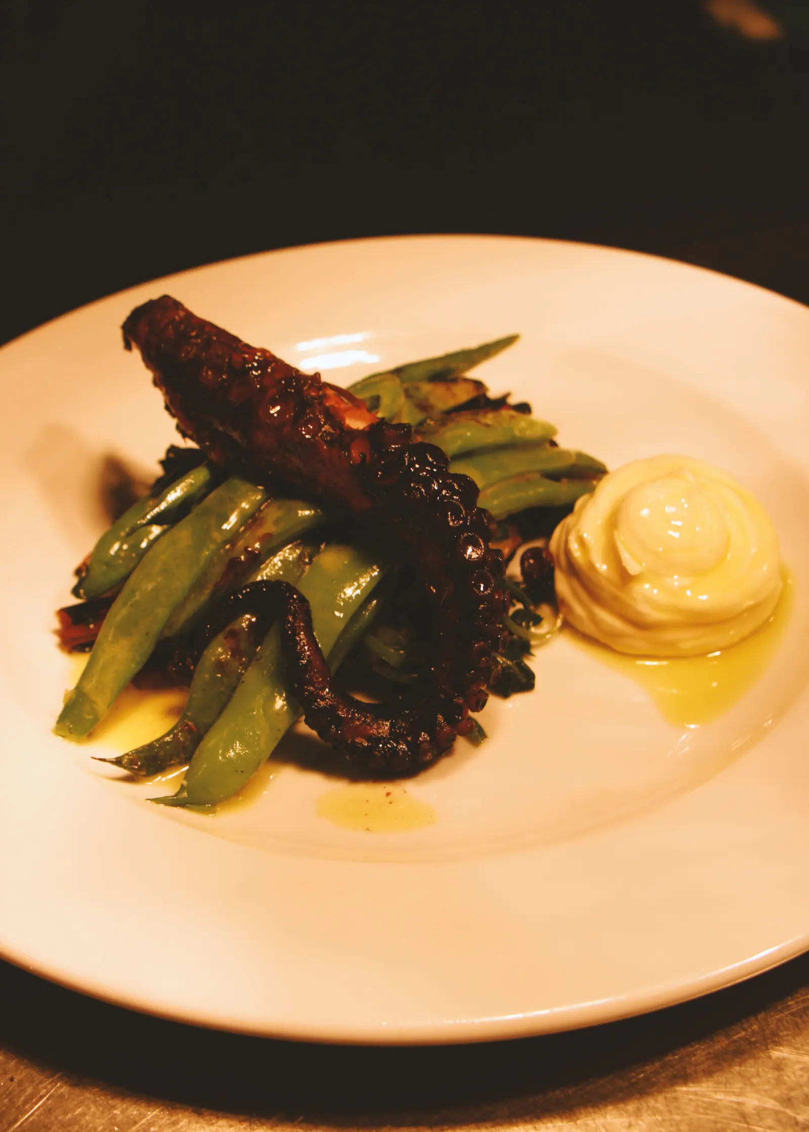 Grilled octopus with greens and a smear of sauce
